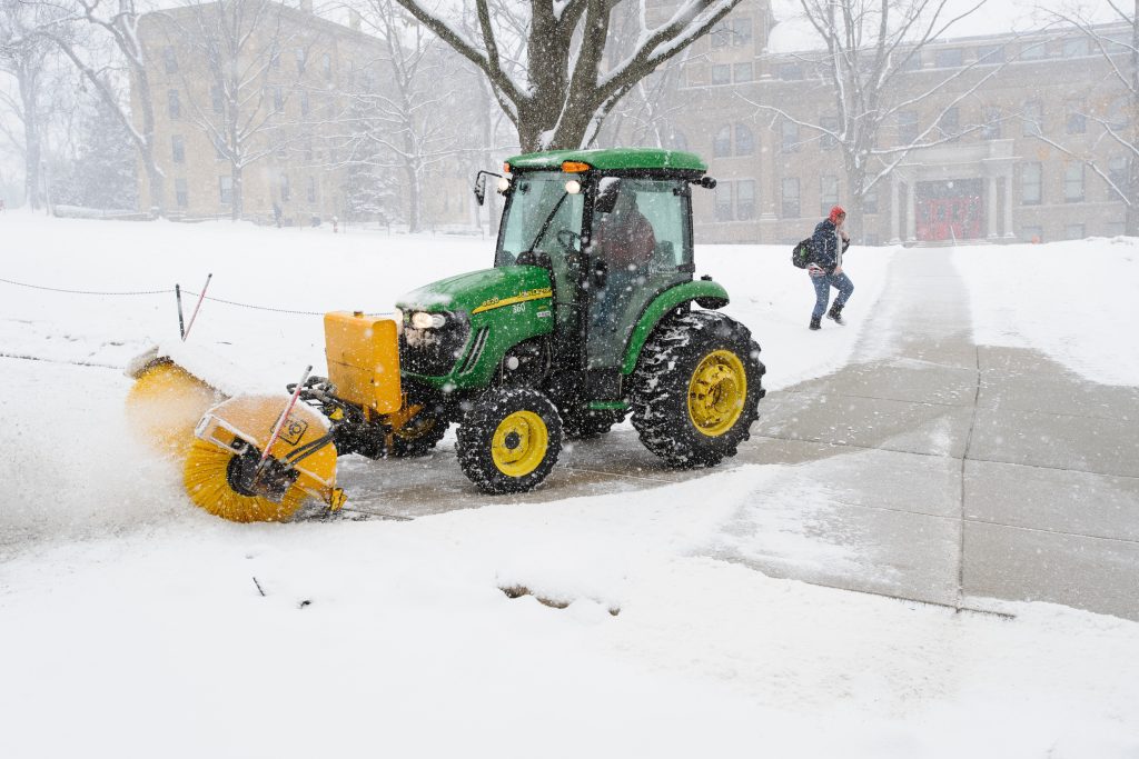 Campus tractor clearing snow from sidewalks on Bascom Hill