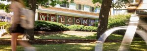 A large welcome sign in a student residence hall, with a bike in the foreground.